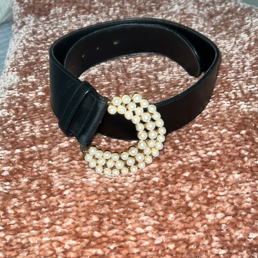 Black leather belt with faux pearl buckle.